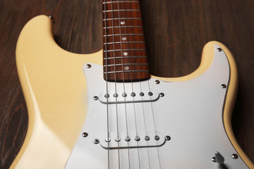 Fototapeta na wymiar Electric guitar on wooden background, close up