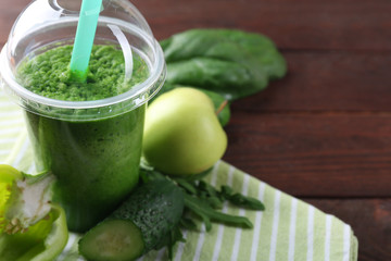 Fresh vegetable juice on wooden background
