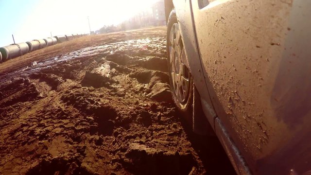 auto car through goes puddles and mud sun glare on water