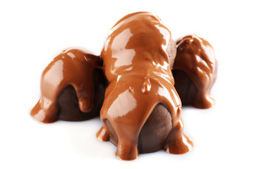 Chocolate poured on candy isolated on white