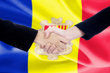 Handshake with Andorran flag in the background
