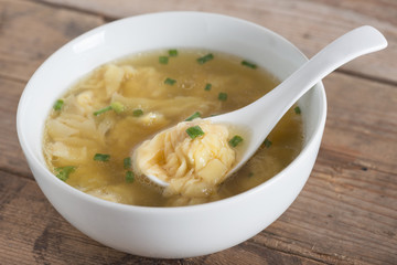 Wonton soup in a bowl. Traditional asian food.