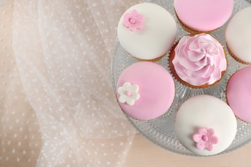 Tasty cupcake on stand, close-up