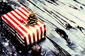 Christmas gifts with  on dark wooden background in vintage style
