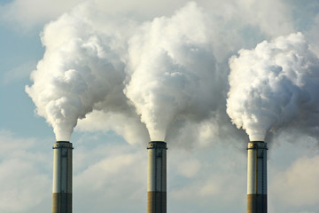 Multiple Coal Fossil Fuel Power Plant Smokestacks Emit Carbon Dioxide Pollution - Powered by Adobe