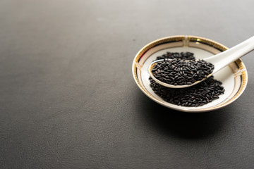 Organic black rice on the Asian spoon
