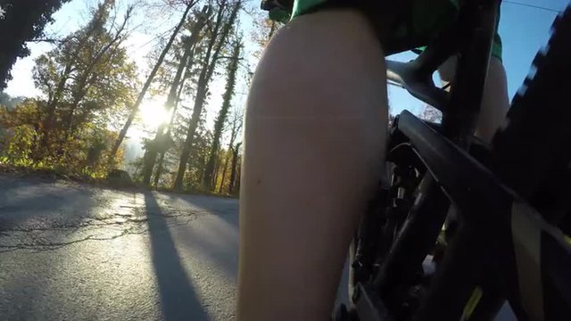 Mountain biking into the sunset on asphalt mountain road