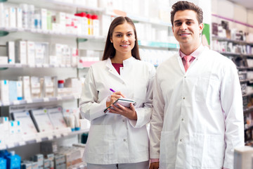 Portrait of two friendly pharmacists working