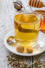 Herb tea in glass cup with honey