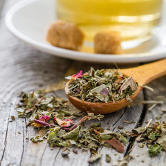 Dry herb tea in wood spoon