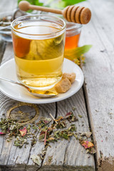 Herb tea in glass cup with honey