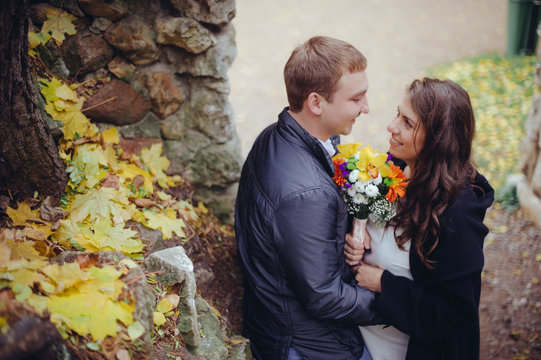A loving couple walking in the park.