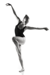 Modern ballet dancer posing on white background