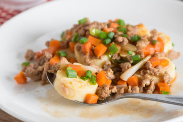 Stir fried tofu with minced pork and carrot ,onion in white plat