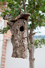 Birdhouse made from the bark of a tree hung
