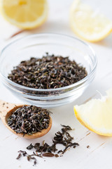 Dry black tea in wood spoon