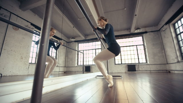 Female Ballet Dancer stretches and practices,dolly shot