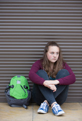 Fototapeta na wymiar Homeless Teenage Girl On Streets With Rucksack