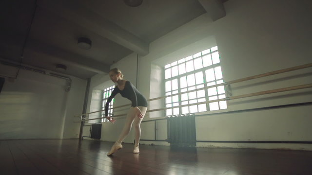 graceful girl practicing ballet in the Studio, slow motion , performs the elements of dance