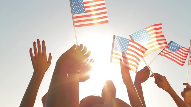Patriots waving flags of America.