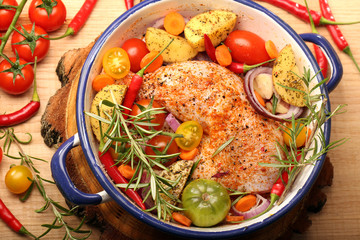 Chicken legs with vegetables and herbs ready for roasting