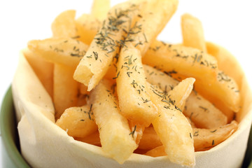 French fries in packing on a white table on a grey background