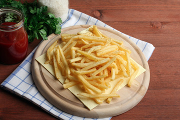 French fries in packing on a white table on a grey background
