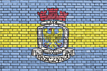 Obraz premium flag of Pszczyna painted on brick wall