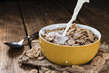 Pouring Milk in a bowl with Cornflakes