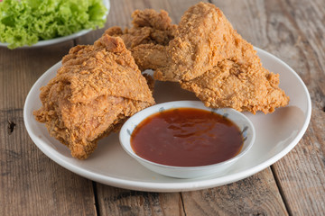 Fried chicken with sauce on a white plate.