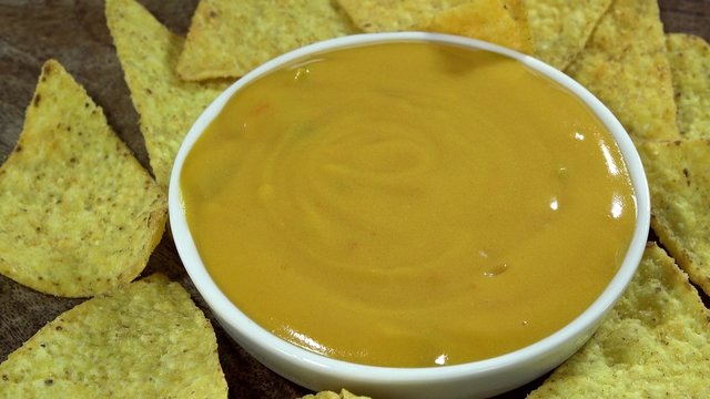 Rotating Nachos with cheese dip (not loopable 4K UHD footage)