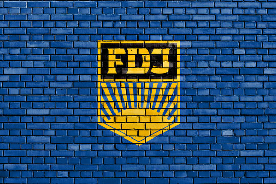 flag of Free German Youth painted on brick wall