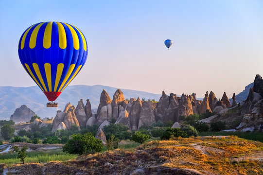 Cappadocia hot air balloon flying over bizarre rock landscape in Turkey