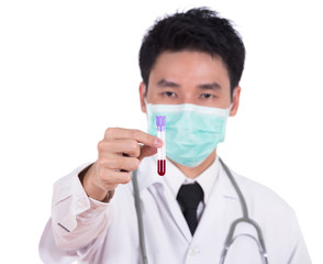 doctor in mask research a medical test glass with blood