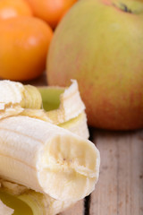 Mandarin Apples and Bananas on wooden plate