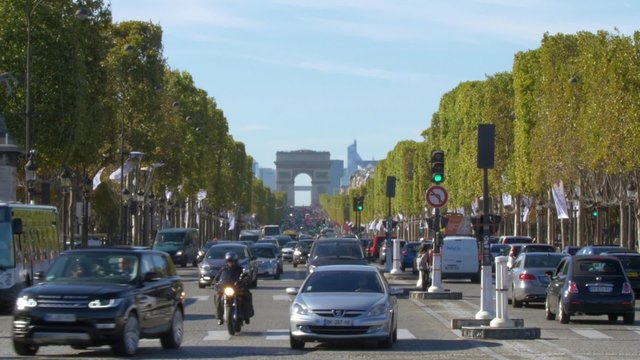 Paris, car traffic in the Avenue des Champs-Elysees with the Arc de Triomphe in the background