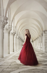 Woman in red dress near ancient columns, San Marco Square, Venice, Italy