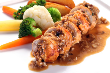 Sliced roasted boneless chicken breast with mushroom sauce on wh