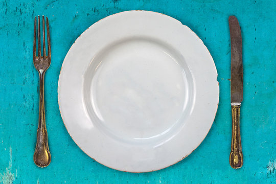 Retro styled image of an empty dinner plate