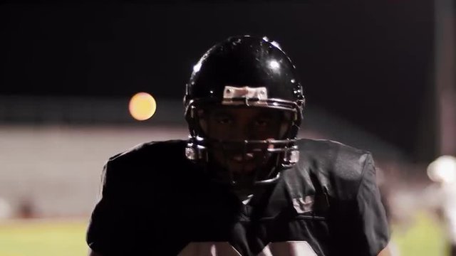 Close up portrait of a football player on the field getting hyped
