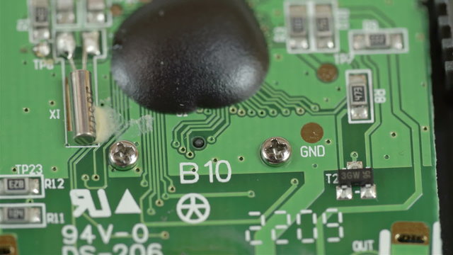 The microchip of a USB stick. Inside view of the micro chip there are some black boards and boxes