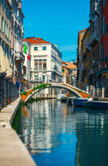 Obraz na płótnie Canvas Bridge over channel among houses in Venice Italy