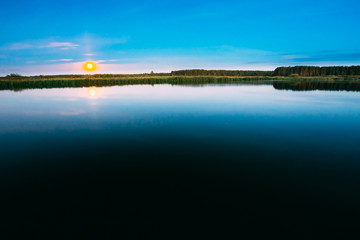 Wooden boards pier on Calm Water Of Lake, River