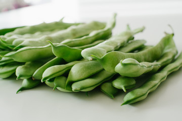 Green bean pods on white background