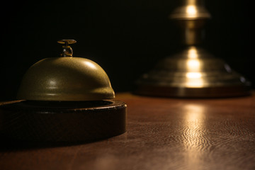 Desk bell with blurred lamp in the background
