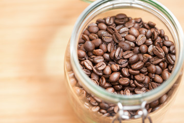 Fototapeta premium Coffee beans in a glass bowl. Shallow dof