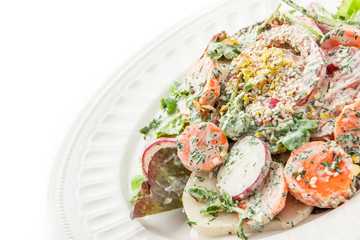 Vegetable salad with greens and sesame on the white background