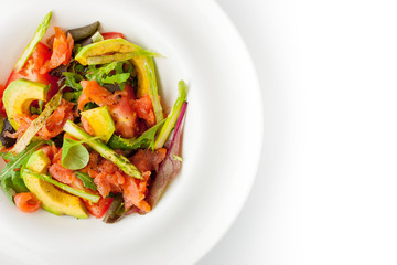 Salad with avocado , trout and asparagus on the white plate top view