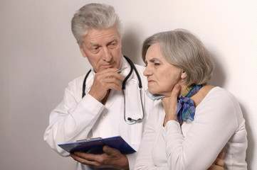 Elderly doctor with a patient 
