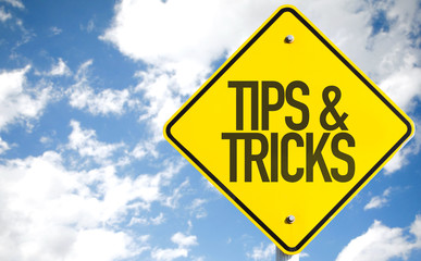 Tips & Tricks sign with sky background